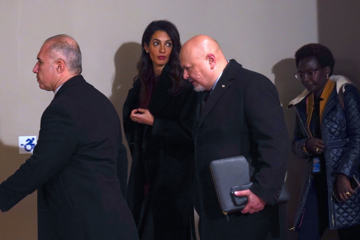Amal Clooney and Karim Khan walking after a UN Security Council meeting  