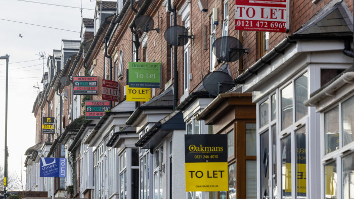 A row of terraced houses with letting signs 