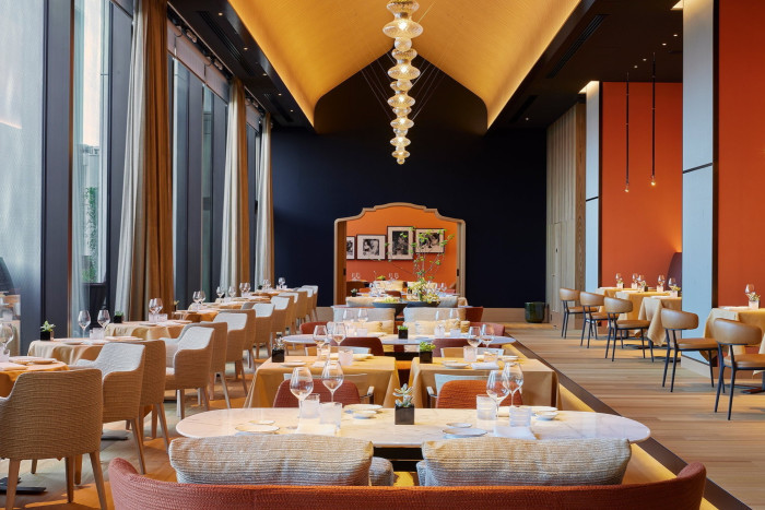 The vaulted dining space in the hotel’s Michelin-starred Il Ristorante – Niko Romito, with a yellow ceiling and orange and dark-blue walls