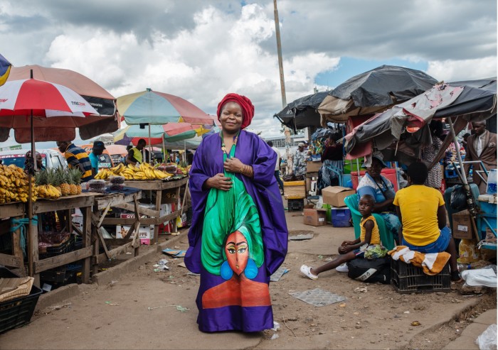 A woman in a colourful robe at a street market