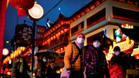 People walk by an area decorated with lanterns ahead of the Chinese Lunar New Year festivity in Shanghai