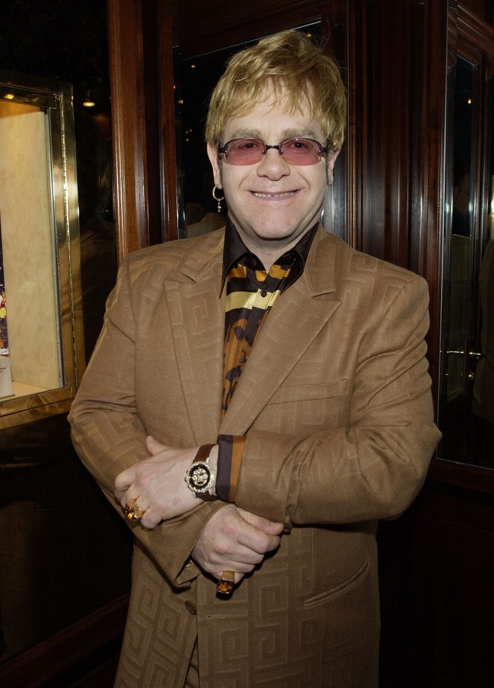 John curates the Elton John Watch Collection to help fight AIDS in 2002