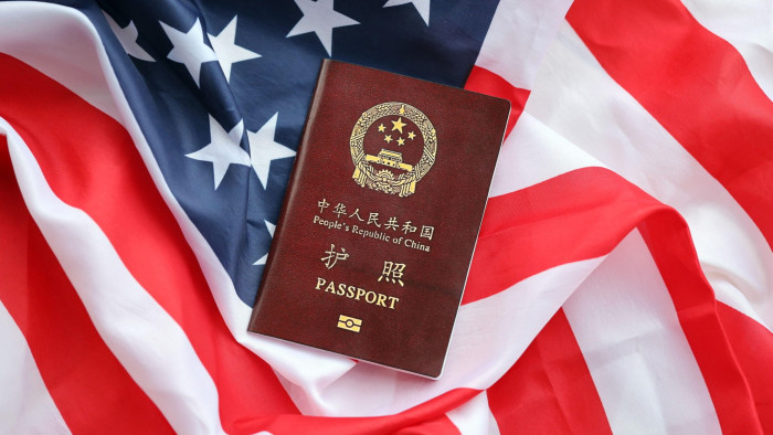 Passport of People’s Republic of China on United States flag