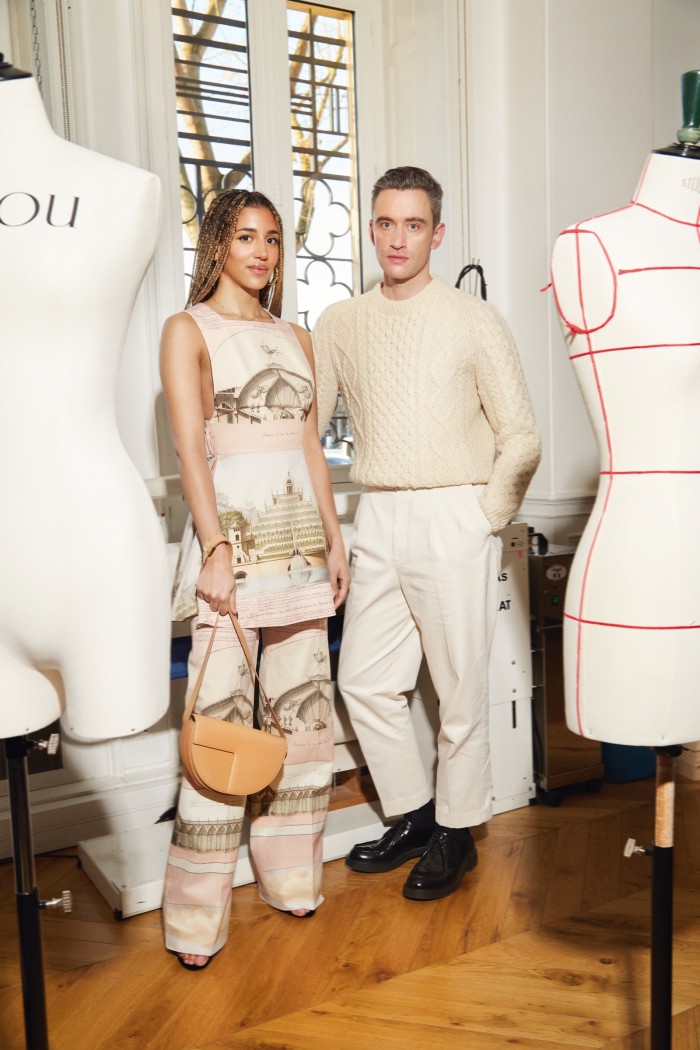 Guillaume Henry with musician Kimberose wearing PATOU apron-pleated dress, €990, trousers, €890, velour sandals, POA, brass hoop earrings, €350, and leather bag, €950
