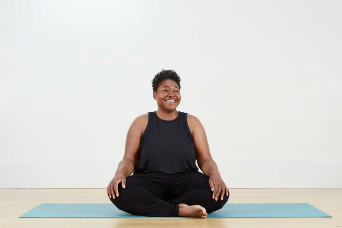 Paula Hines sitting on a yoga mat