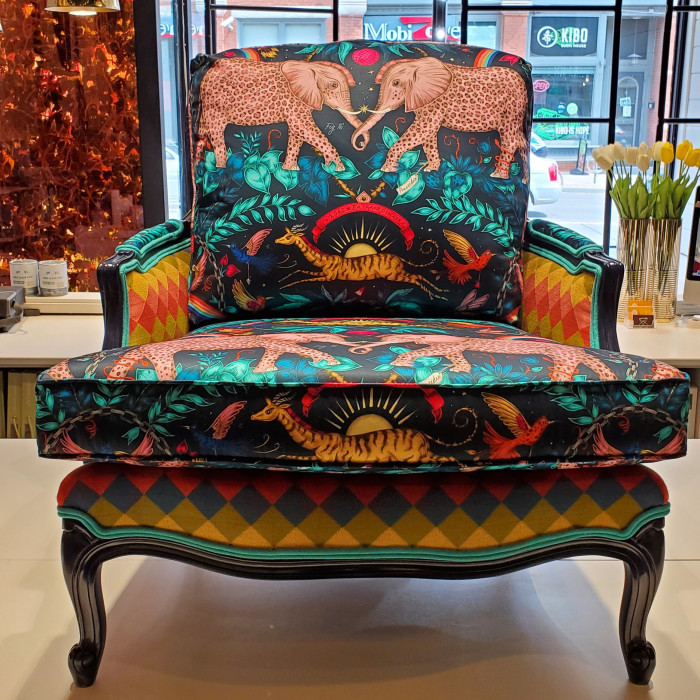 Classic pieces upholstered with strident contemporary patterns and prints . . . A vintage wooden chair with cushions embellished with a striped pattern and wildlife print at Kendall & Co