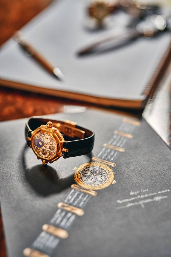 A Genta complication with perpetual calendar and minute repeater lying on a notebook