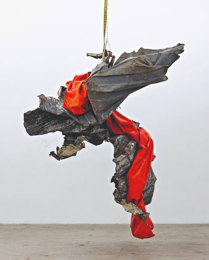 A dangling dance between twisted metal and red fabric