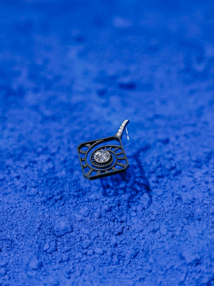 A white-gold, iron and old-mine diamond earring (one of pair)