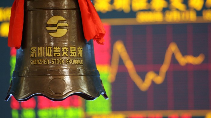The bell used when introducing new stocks in front of a stock quotations screen at Shenzhen stock exchange