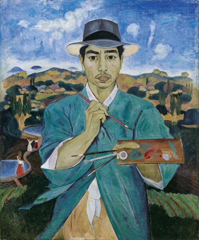 In a painting, a young man dressed in a white fedora and a turquoise over-shirt holds a brush and a colour palette while standing before a hilly rural landscape