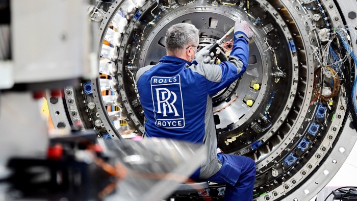 A Rolls-Royce worker constructing an aero engine 