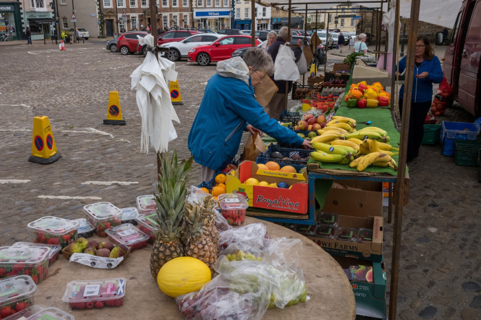 People at a fruit market stall in Richmond town centre, North Yorkshire