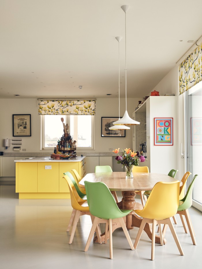 The white-and-yellow Omega kitchen, with its Senso resin floor