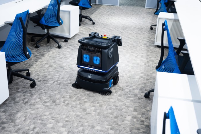 a cleaning robot at an aisle in an office