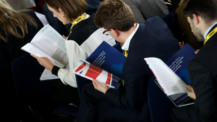 People view the Conservative party’s manifesto at its launch event in Northamptonshire