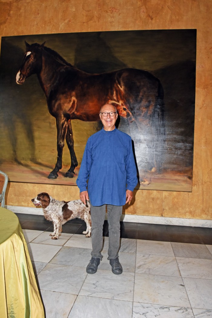 Axel Vervoordt, pictured at home in ‘s-Gravenwezel with his springer spaniel Inu, has such affection for his former horse Raio (who died this year), he had him captured in a painting by the artist Michaël Borremans. Now in his 70s, the Belgian designer is still a keen rider. “I love horses – my father was a horse dealer,” he says of his regular gallops, which take him across his 62-acre estate.  