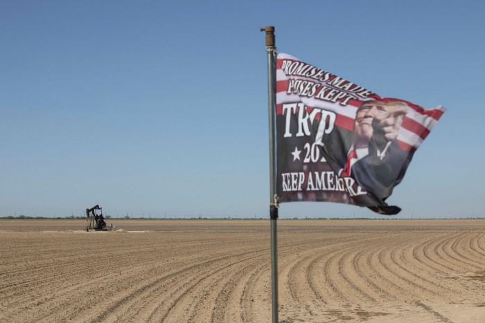 An active pump jack stands past a Trump 2020 flag flying at a private ranch in Midland, Texas, last April. That month West Texas Intermediate, the US benchmark crude contract, traded below zero for the first time