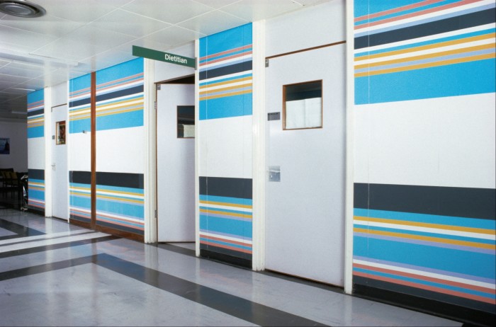 Turquoise, yellow and green stripes on a wall next to a door marked ‘Dietician’