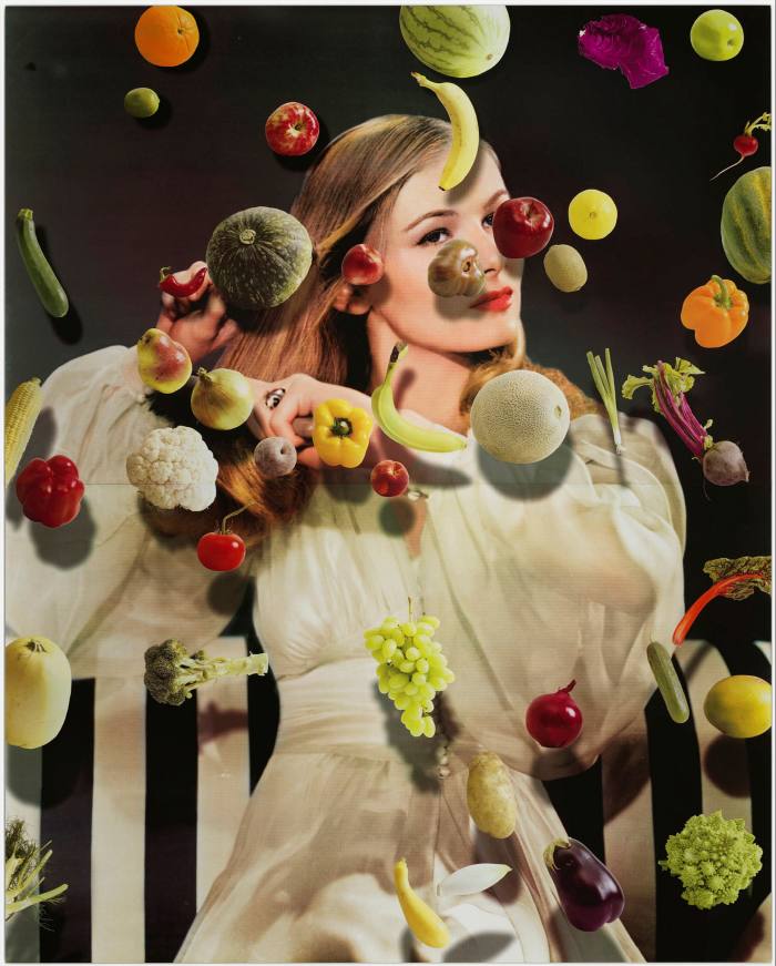 A photo of a woman underneath various fruit