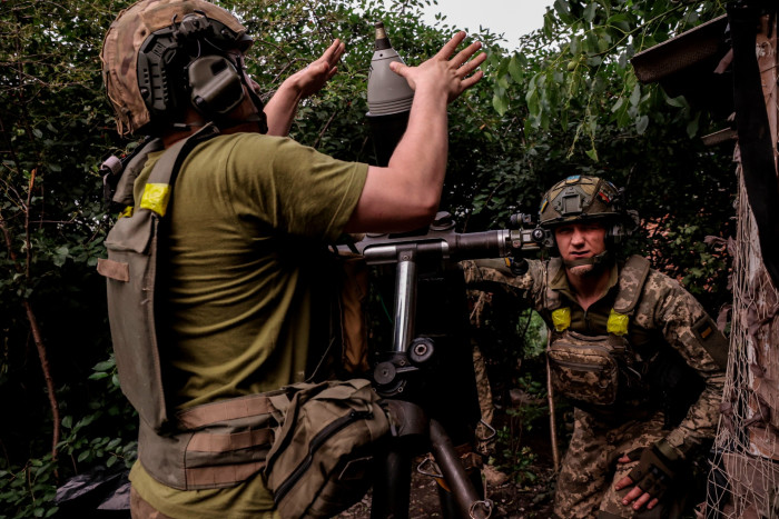Ukrainian soldiers load 120mm mortars in Donetsk