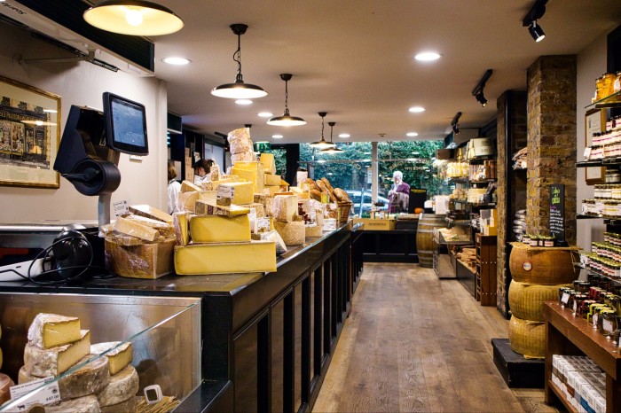 Hard cheeses on the counter inside the store