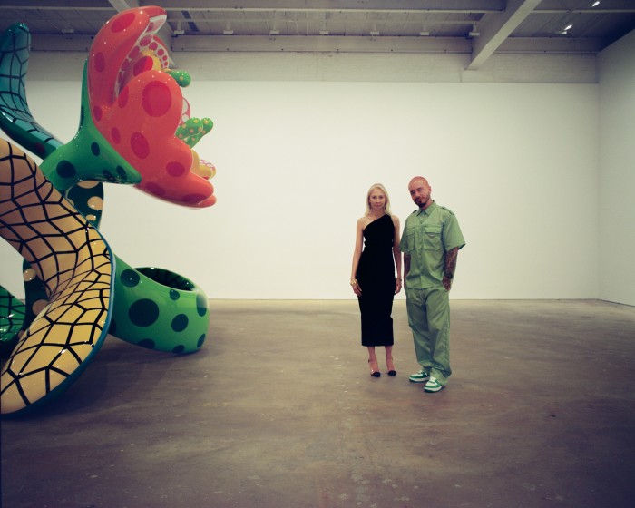 Melissa Chiu and J Balvin in front of I Spend Each Day Embracing Flowers, 2023, by Yayoi Kasuma, at David Zwirner, New York