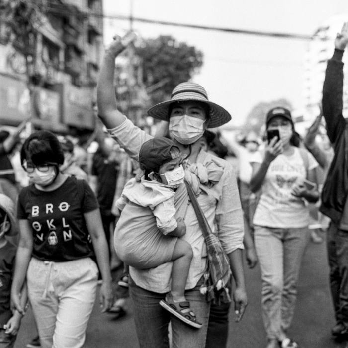 A mother gestures her defiance of the ruling junta