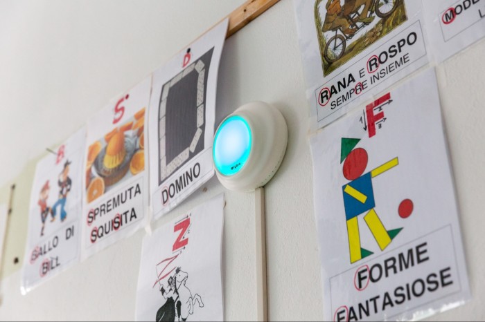 A Fybra air quality monitor on the wall of a classroom