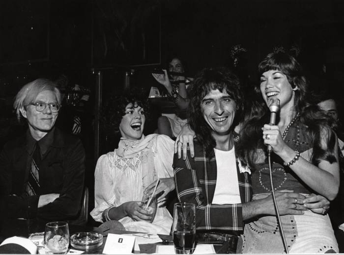 Cooper (second from right) with Andy Warhol (far left) and model/singer Barbi Benton (far right) at the Playboy Club, New York, 1974