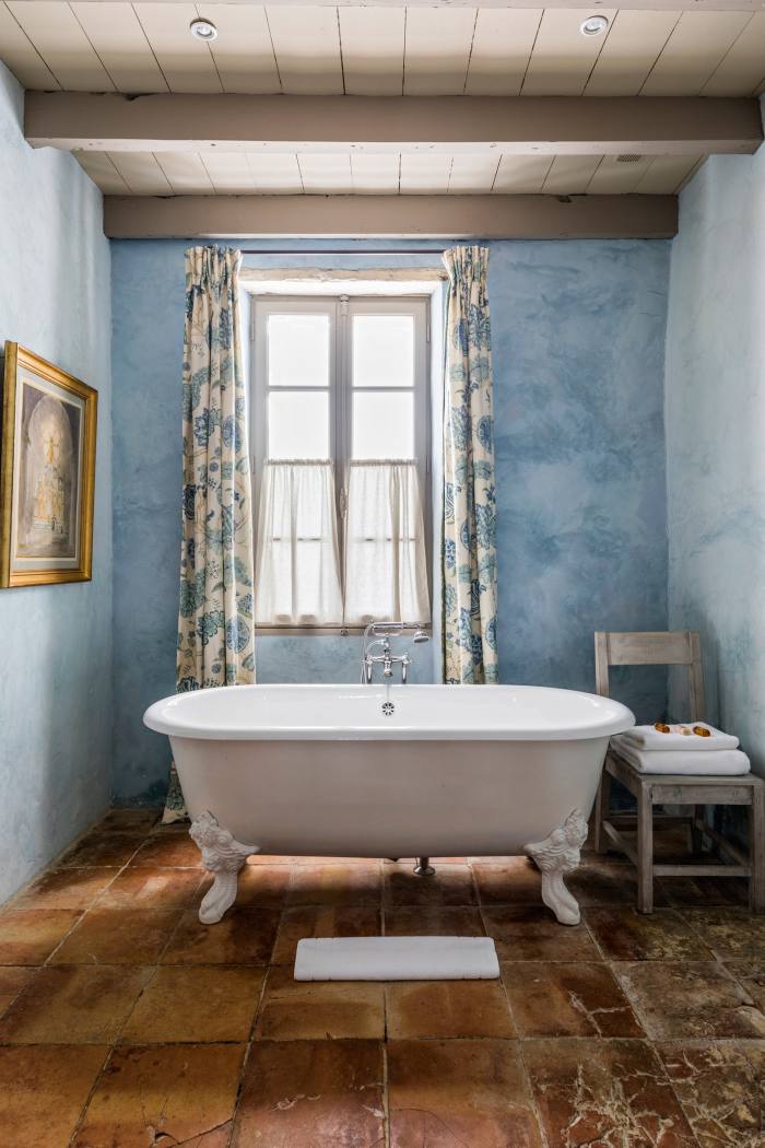 A bathroom with toile de Jouy curtains