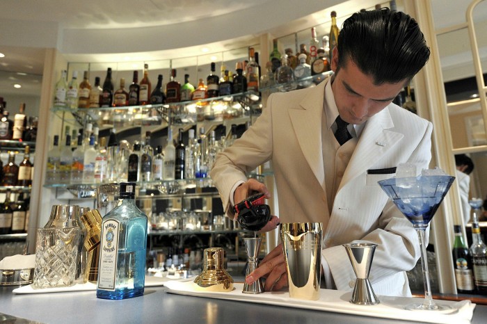 A cocktail waiter mixes drinks in the American Bar. The hotel has been losing money since the current owners purchased it in 2005