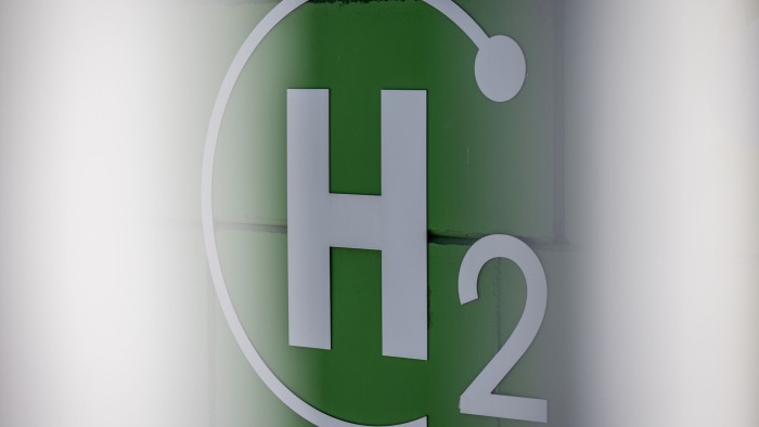 Close-up of a green and white sign featuring the chemical symbol for hydrogen, ‘H2’