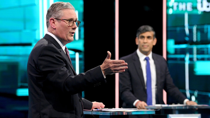 Sir Keir Starmer makes a point while Rishi Sunak looks on during the debate