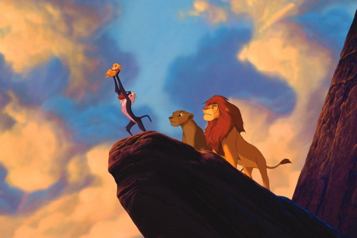 Rafiki holds Simba and Nala’s cub aloft on Pride Rock in a promotional shot for The Lion King (1994)