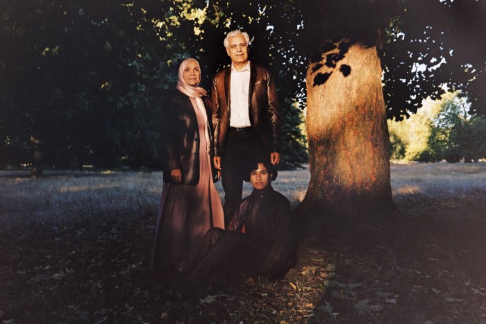 Shahina Anwar, left, primary school teaching assistant, wears  Berluti deerskin jacket, POA. Dress and headscarf, model’s own. Jamshed Anwar, right, professor in computational chemistry at Lancaster University, wears Berluti deerskin jacket, £5,400. Canali cotton dress shirt, £195, and jeans, £310. John Lobb calfskin Croft shoes, £1,180. Belt, model’s own. Haniyyah Anwar, seated, tech company worker, singer and poet running monthly workshops, ‘Poetry in the Park’, wears Berluti deerskin shirt, matching roll neck and trousers, all POA. John Lobb calfskin Lawry boots, £1,365