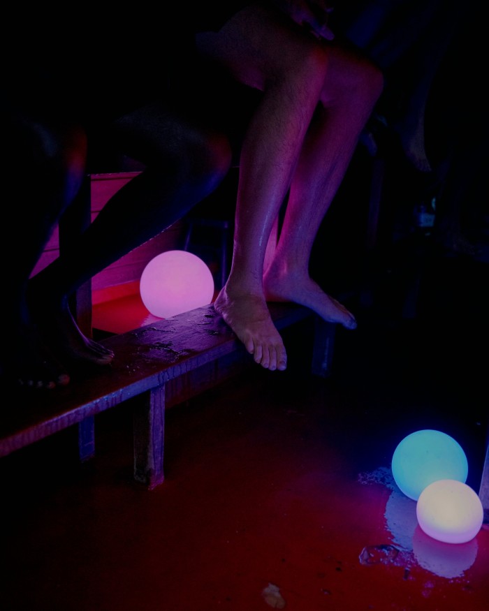 Blue and purple coloured globe lights in the darkened Butcher’s Heat sauna