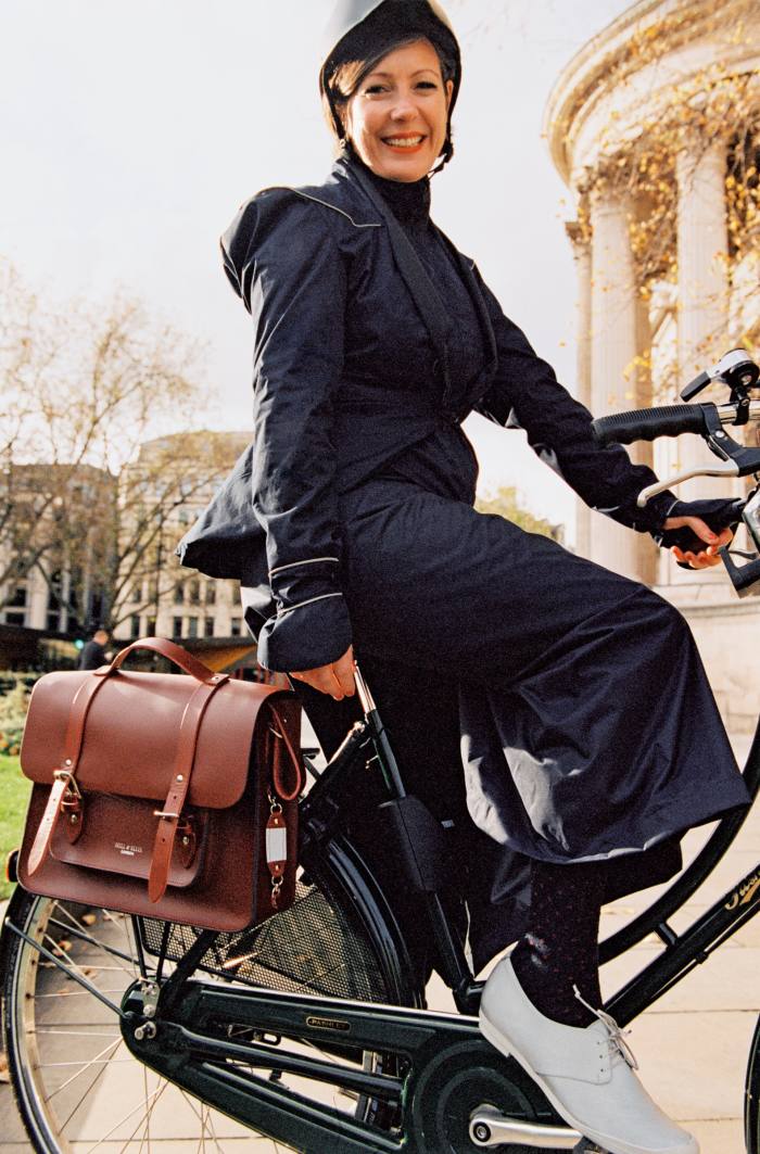 Beatrice wears Dashel Urban Cycle Helmet, £79. Georgia in Dublin Hustle & Bustle jacket, €165, and Rainwrap skirt, €63. Tracey Neuls Geek Reflective Cycle Sneakers, £150. Hill & Ellis leather Satchel Cycle Bag, £200