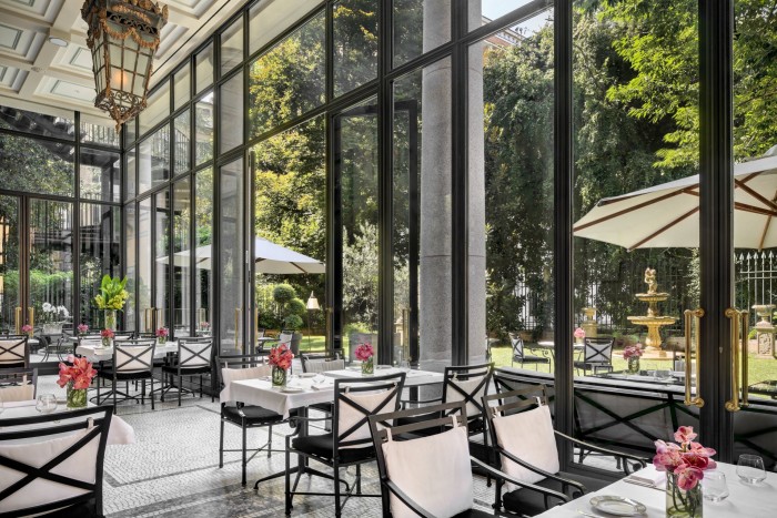 The Palazzo Parigi hotel’s ‘winter garden’ – a glass-enclosed restaurant looking onto the main garden 