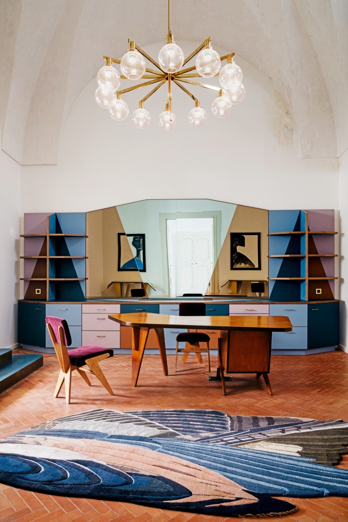 The reception area features a coloured-mirror Martino Gamper cabinet, as well as 1950s chairs and desk by Brazilian architect/designer José Zanine Caldas, a 1960 ceiling light by by Hans-Agne Jakobsson and a Feathers Freeform Big rug by Maarten De Ceulaer for CC-Tapis