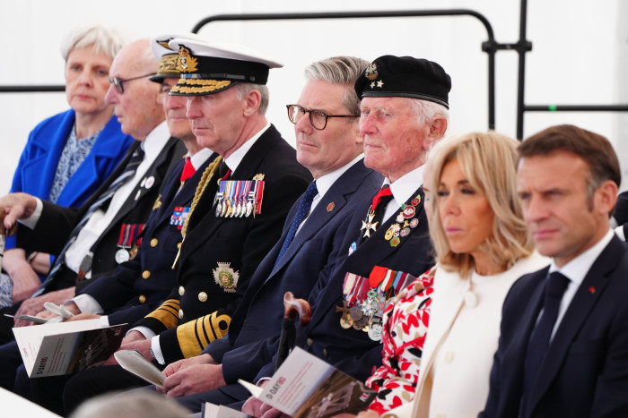 World leaders sit with military at the D-Day ceremony 