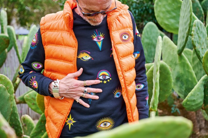 Big Eye polyester puffa vest in orange, €300. All Eyes On You organic cotton-mix embroidered sweater, €435