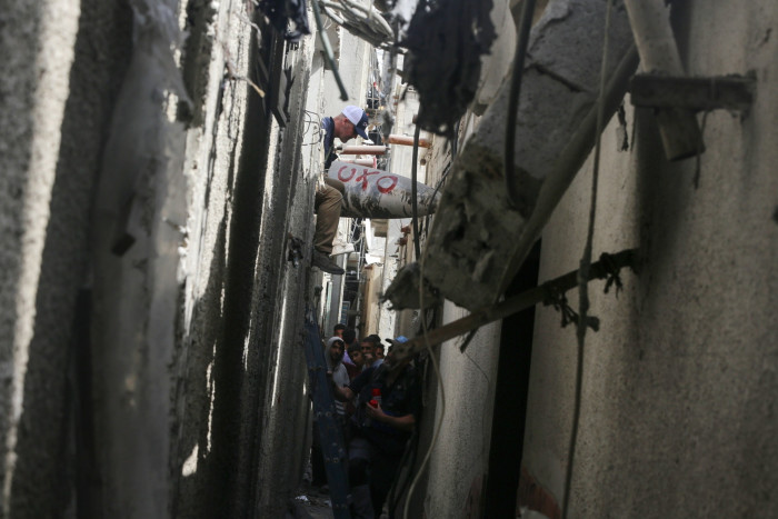 An unexploded Israeli bomb sits in an alleyway in Deir Balah in the central Gaza Strip