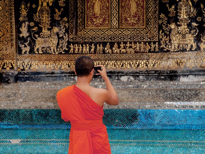A monk at Wat Xieng Thong temple