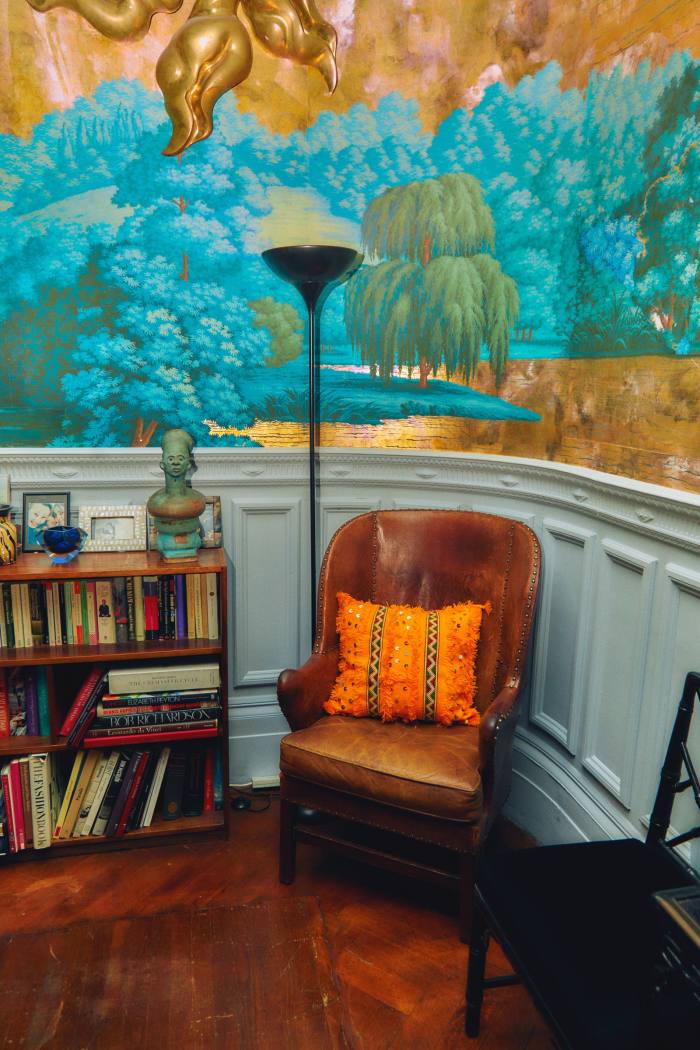 De Gournay wallpaper in Azagury-Partridge’s sitting room, with a leather antique chair that she swapped for some jewellery and a yellow Moroccan cushion
