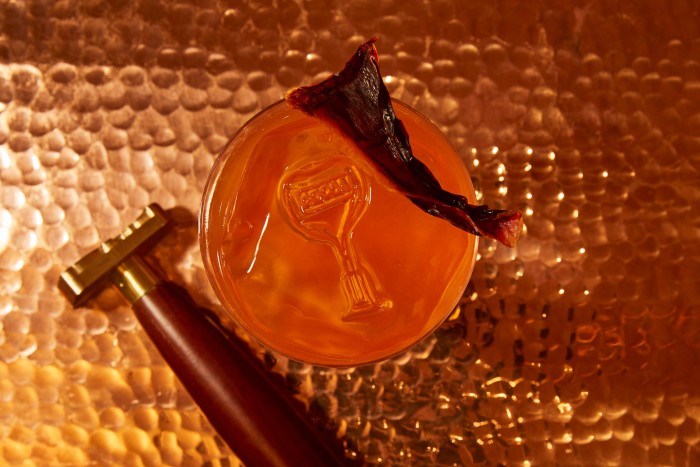 Bondye Bon Dieu punch, featuring whiskey, mandarin ferment, strawberry liqueur and dried red pepper