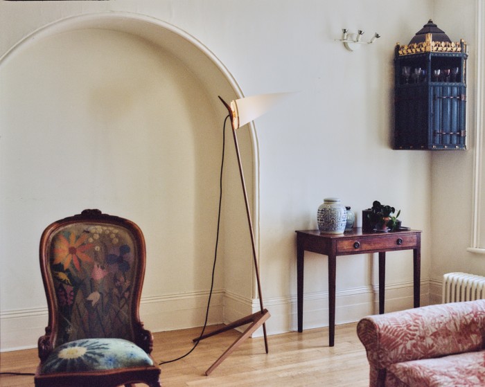The Edward Armitage-designed floor lamp with a gilted corner cupboard by Joseph and sofa cover by Marthe
