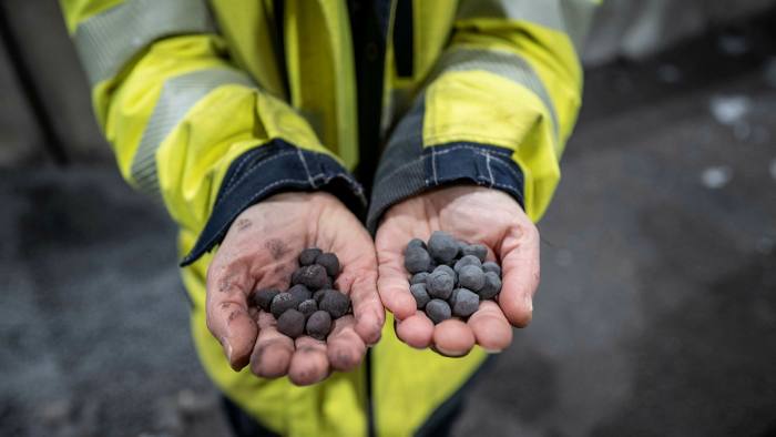 worker holding coal in his hands
