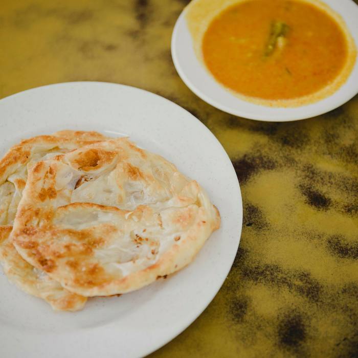 Egg and cheese pratas and a bowl of fish curry at Mr Mrs Mohgan