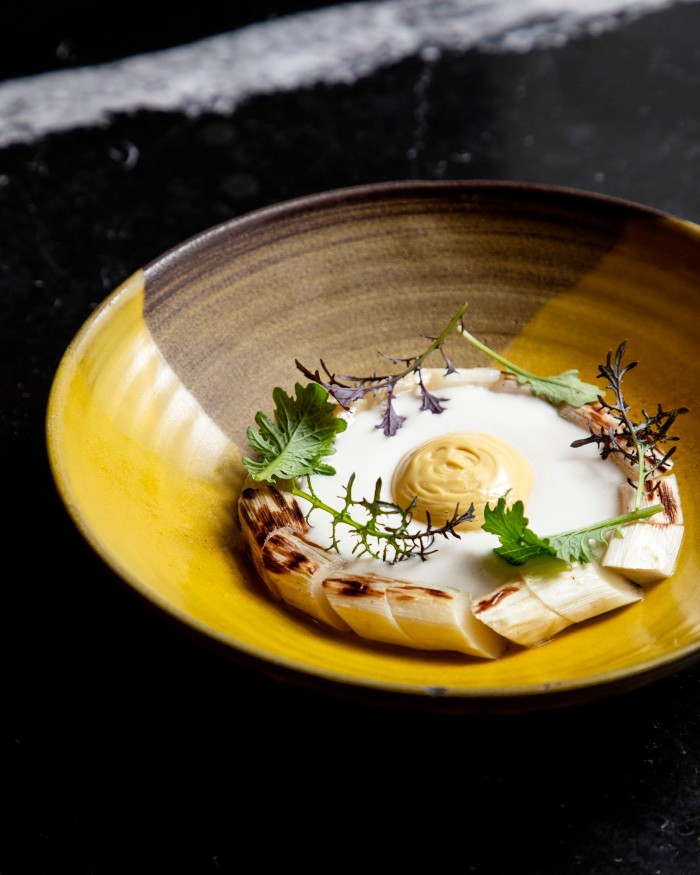 A bowl of grilled white asparagus with cured egg yolk at Barabba